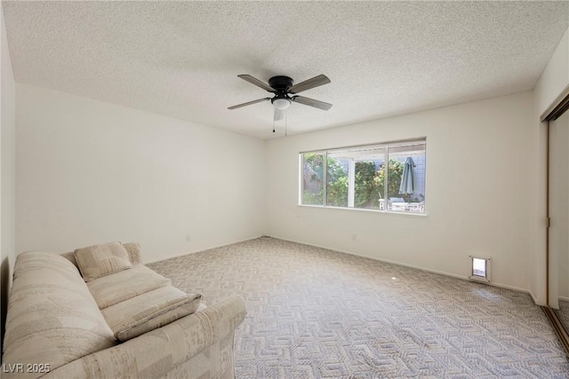 unfurnished room featuring a ceiling fan, carpet floors, and a textured ceiling