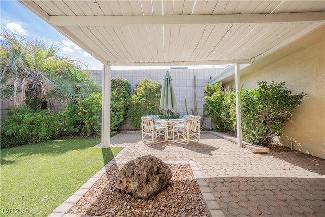 view of patio featuring fence