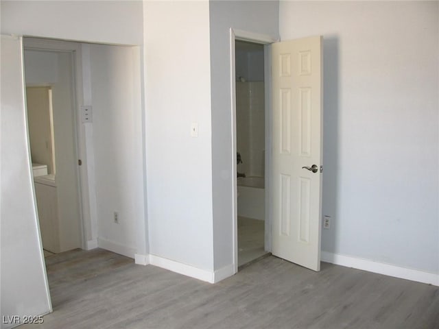 861 Mcmurray Dr, Pahrump, NV 89060 - unfurnished bedroom with baseboards and light wood-type flooring