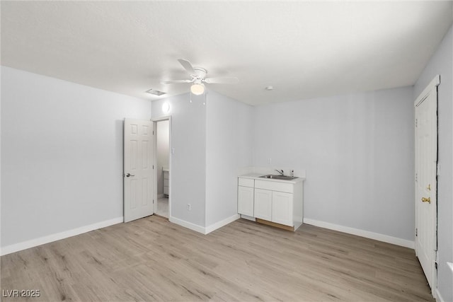 861 Mcmurray Dr, Pahrump, NV 89060 - unfurnished room featuring baseboards, ceiling fan, a sink, and light wood-style floors