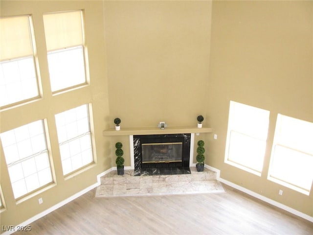 861 Mcmurray Dr, Pahrump, NV 89060 - unfurnished living room featuring a tile fireplace, baseboards, and wood finished floors