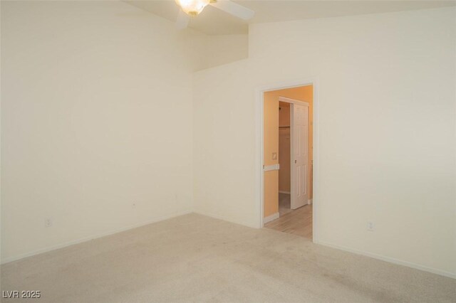 9323 W Rochelle Ave, Las Vegas, NV 89147 - empty room featuring light carpet, ceiling fan, vaulted ceiling, and baseboards