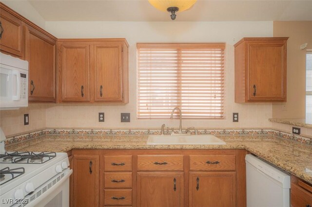 9323 W Rochelle Ave, Las Vegas, NV 89147 - kitchen with white appliances, a sink, tasteful backsplash, and light stone counters