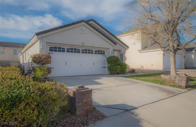 9323 W Rochelle Ave, Las Vegas, NV 89147 - ranch-style house with a garage, stucco siding, and driveway