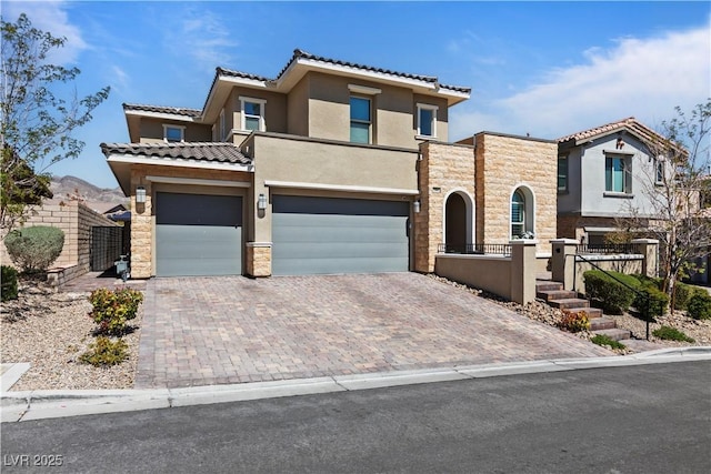 11834 Albissola Ave, Las Vegas, NV 89138 - view of front facade with a tile roof, a garage, decorative driveway, and stucco siding