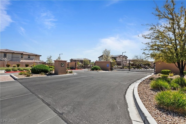 11834 Albissola Ave, Las Vegas, NV 89138 - view of street featuring street lights, a gated entry, a gate, and curbs
