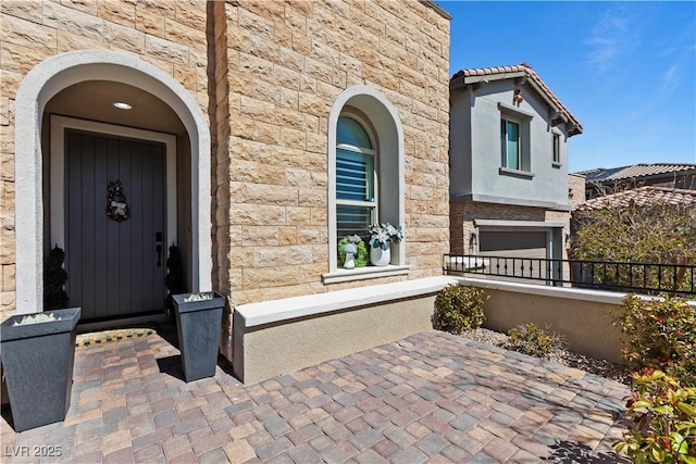 11834 Albissola Ave, Las Vegas, NV 89138 - property entrance featuring stone siding, stucco siding, and a garage