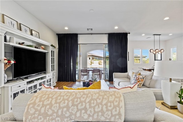 11834 Albissola Ave, Las Vegas, NV 89138 - living area with an inviting chandelier, wood finished floors, visible vents, and recessed lighting