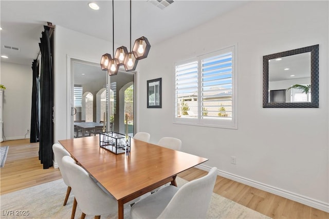 11834 Albissola Ave, Las Vegas, NV 89138 - dining space featuring light wood-style flooring, arched walkways, and visible vents
