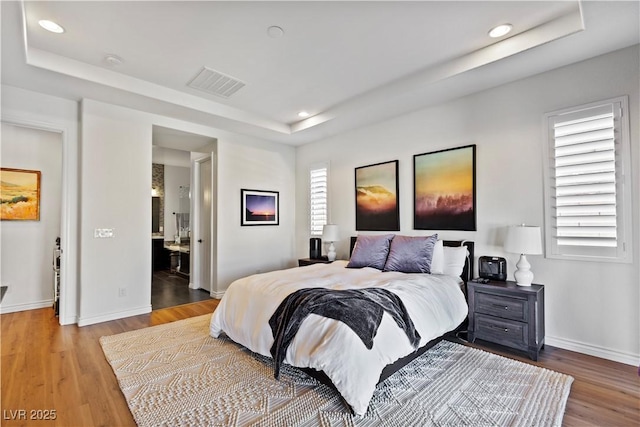 11834 Albissola Ave, Las Vegas, NV 89138 - bedroom featuring recessed lighting, baseboards, a raised ceiling, visible vents, and wood finished floors