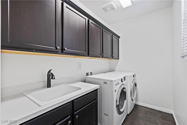 11834 Albissola Ave, Las Vegas, NV 89138 - laundry area with baseboards, washing machine and clothes dryer, a sink, visible vents, and cabinet space