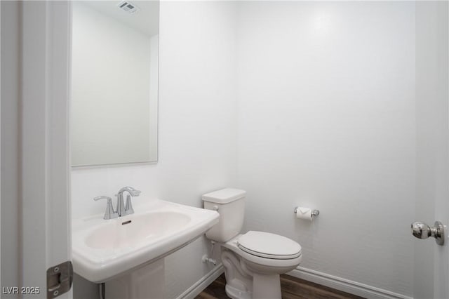 600 N Carriage Hill Dr Unit 2174, Las Vegas, NV 89138 - half bath with wood finished floors, toilet, baseboards, and a sink