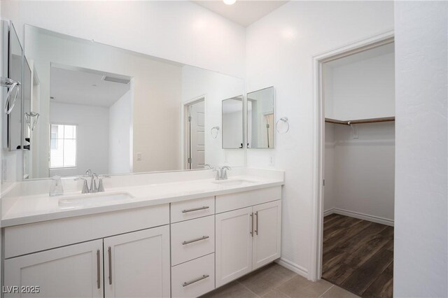 600 N Carriage Hill Dr Unit 2174, Las Vegas, NV 89138 - full bath featuring double vanity, a walk in closet, baseboards, and tile patterned flooring