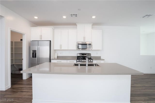 600 N Carriage Hill Dr Unit 2174, Las Vegas, NV 89138 - kitchen with stainless steel appliances, a center island with sink, a sink, dark wood-style flooring, and white cabinetry