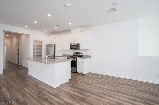 600 N Carriage Hill Dr Unit 2174, Las Vegas, NV 89138 - kitchen with appliances with stainless steel finishes, a sink, dark wood-type flooring, baseboards, and a kitchen island with sink