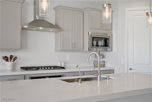 8564 Scalpay St, Las Vegas, NV 89166 - kitchen with appliances with stainless steel finishes, wall chimney range hood, light countertops, and a sink
