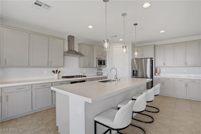 8564 Scalpay St, Las Vegas, NV 89166 - kitchen featuring a sink, appliances with stainless steel finishes, wall chimney range hood, gray cabinets, and light tile patterned floors