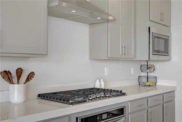 8564 Scalpay St, Las Vegas, NV 89166 - kitchen featuring appliances with stainless steel finishes, wall chimney range hood, and light countertops
