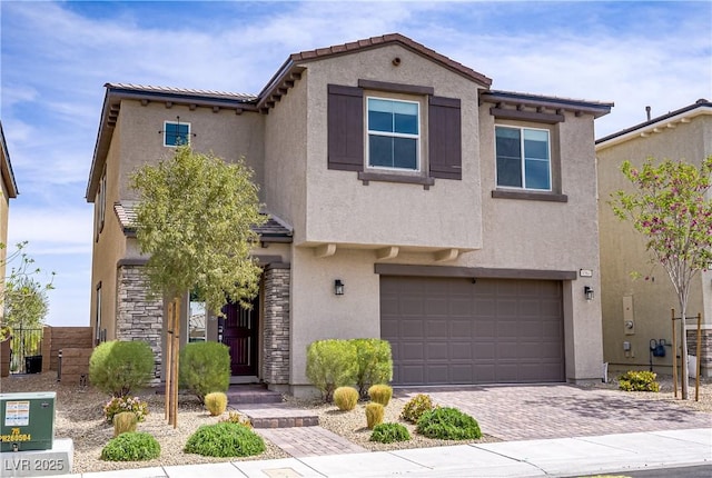 8564 Scalpay St, Las Vegas, NV 89166 - view of front of property with an attached garage, stucco siding, stone siding, and decorative driveway