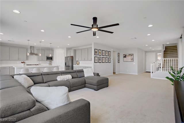 8564 Scalpay St, Las Vegas, NV 89166 - living area with recessed lighting, baseboards, stairway, light colored carpet, and ceiling fan