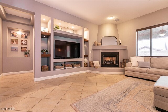 3920 Eiderdown Pl, North Las Vegas, NV 89084 - tiled living room featuring a large fireplace, baseboards, visible vents, and built in shelves