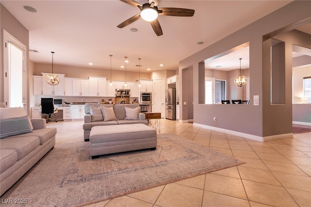 3920 Eiderdown Pl, North Las Vegas, NV 89084 - living room with recessed lighting, baseboards, light tile patterned flooring, and ceiling fan with notable chandelier