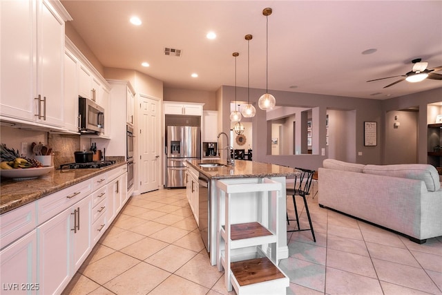 3920 Eiderdown Pl, North Las Vegas, NV 89084 - kitchen with a sink, a kitchen breakfast bar, open floor plan, visible vents, and appliances with stainless steel finishes