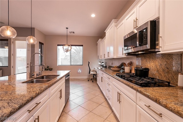 3920 Eiderdown Pl, North Las Vegas, NV 89084 - kitchen with stainless steel appliances, a sink, baseboards, decorative backsplash, and recessed lighting
