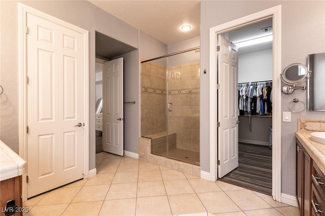 3920 Eiderdown Pl, North Las Vegas, NV 89084 - bathroom with vanity, visible vents, tile patterned flooring, a shower stall, and baseboards