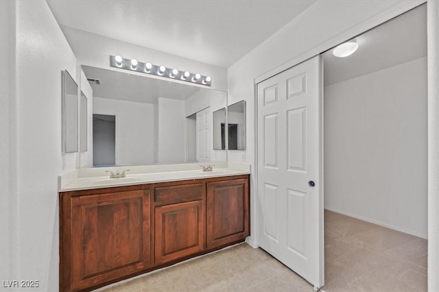 full bathroom with double vanity, a sink, and visible vents