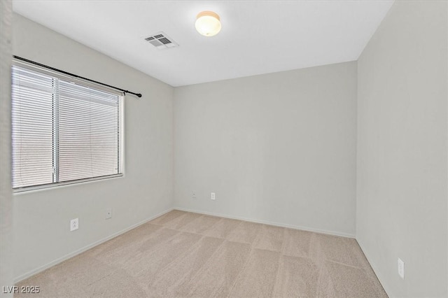 unfurnished room with carpet flooring, visible vents, and baseboards