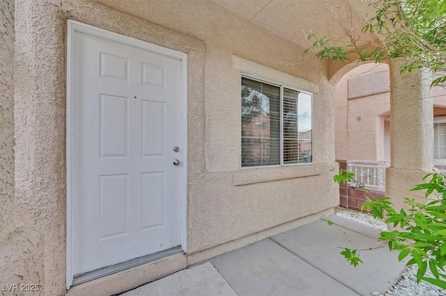 doorway to property with stucco siding