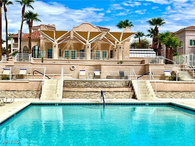 community pool featuring stairway and fence