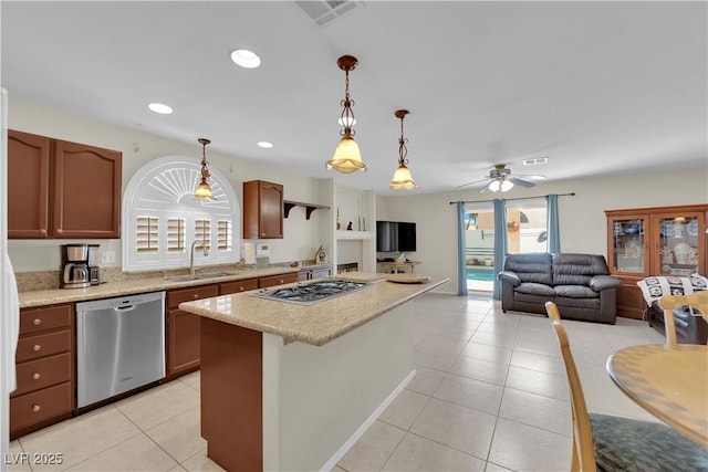 7405 Blue Sage Ct, Las Vegas, NV 89129 - kitchen with stainless steel appliances, light tile patterned floors, a kitchen island, ceiling fan, and pendant lighting