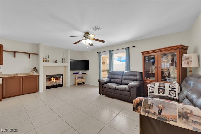 7405 Blue Sage Ct, Las Vegas, NV 89129 - living room featuring ceiling fan, a fireplace, and light tile patterned floors