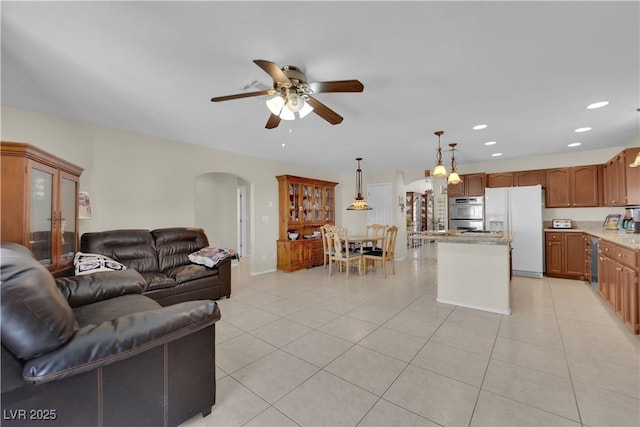 7405 Blue Sage Ct, Las Vegas, NV 89129 - living room with arched walkways, a ceiling fan, light tile patterned floors, and recessed lighting