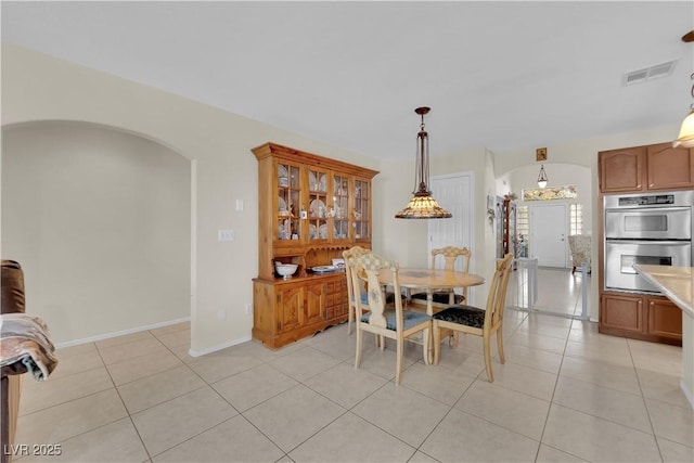 7405 Blue Sage Ct, Las Vegas, NV 89129 - dining space featuring arched walkways and light tile patterned flooring