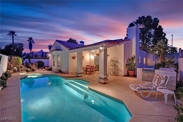 7405 Blue Sage Ct, Las Vegas, NV 89129 - pool at dusk with a patio, area for grilling, and a pool with connected hot tub