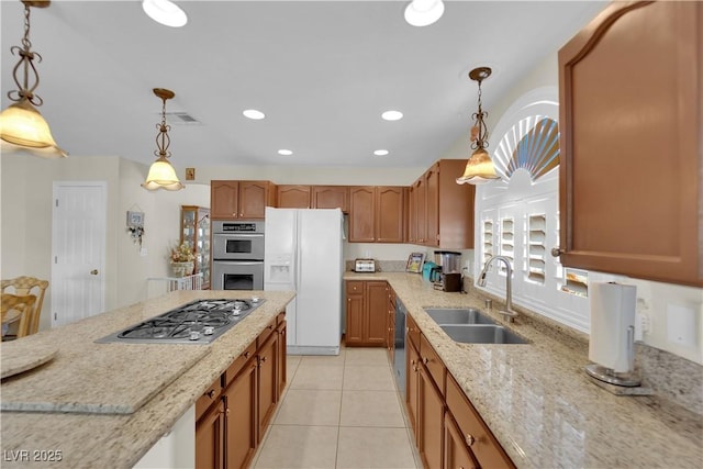 7405 Blue Sage Ct, Las Vegas, NV 89129 - kitchen with appliances with stainless steel finishes, light stone countertops, brown cabinets, pendant lighting, and light tile patterned floors