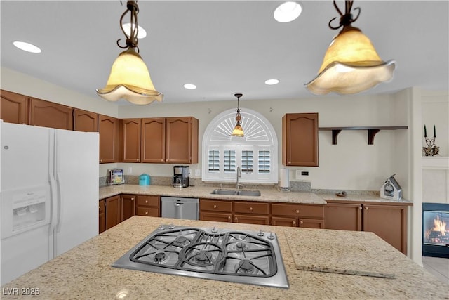 7405 Blue Sage Ct, Las Vegas, NV 89129 - kitchen featuring appliances with stainless steel finishes, decorative light fixtures, brown cabinets, recessed lighting, and light stone counters