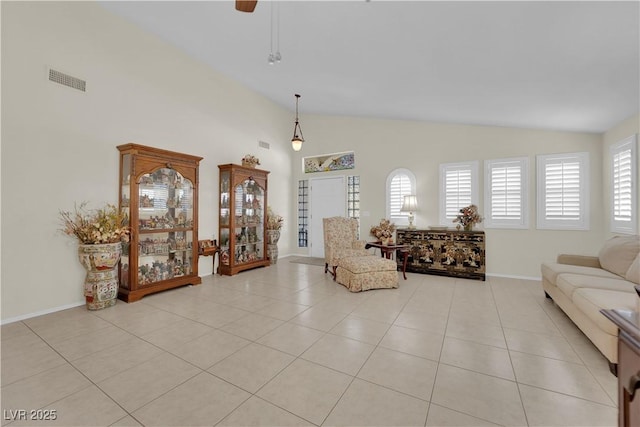 7405 Blue Sage Ct, Las Vegas, NV 89129 - living area with light tile patterned floors, a ceiling fan, and high vaulted ceiling