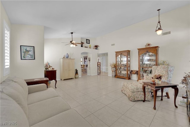 7405 Blue Sage Ct, Las Vegas, NV 89129 - living area featuring light tile patterned floors, ceiling fan, high vaulted ceiling, and arched walkways