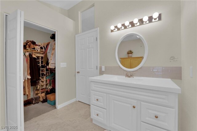 7405 Blue Sage Ct, Las Vegas, NV 89129 - bathroom with vanity, backsplash, and a spacious closet