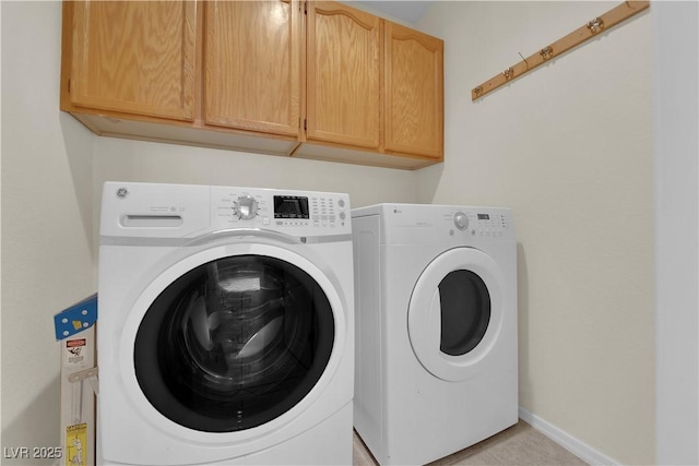 7405 Blue Sage Ct, Las Vegas, NV 89129 - laundry area featuring cabinet space, separate washer and dryer, and light tile patterned floors