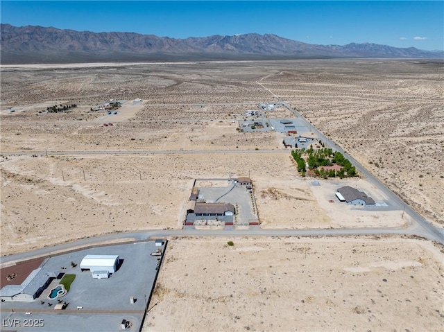 drone / aerial view with a rural view, a mountain view, and a desert view