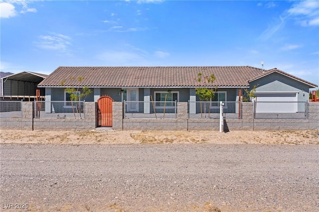 ranch-style house featuring an attached garage, a fenced front yard, stucco siding, and a tile roof
