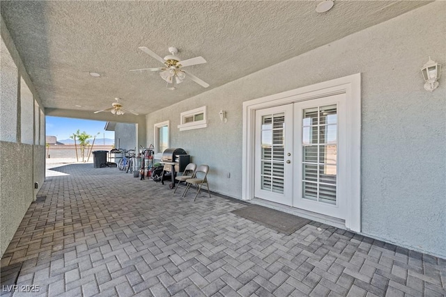 view of patio featuring french doors, ceiling fan, and area for grilling