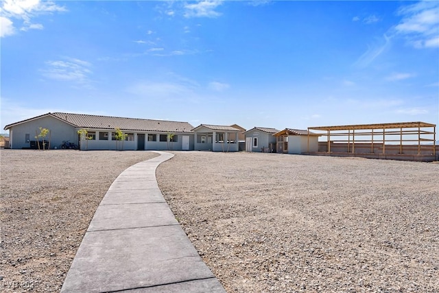ranch-style home with stucco siding and a tile roof