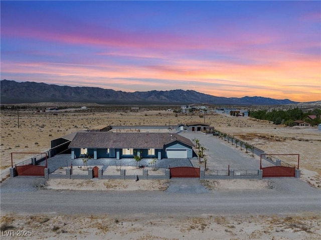 aerial view at dusk with a desert view and a mountain view