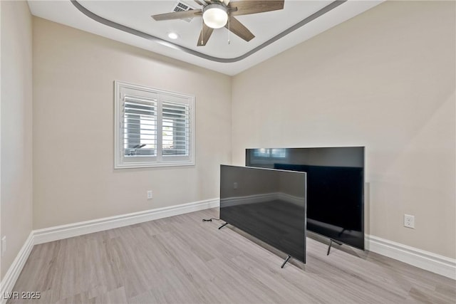 unfurnished office featuring baseboards, ceiling fan, and wood finished floors